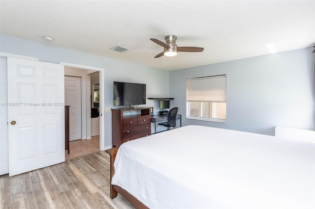 2020 Andromeda Ln, Weston, FL 33327 - bedroom featuring light wood-type flooring, ceiling fan, and a textured ceiling