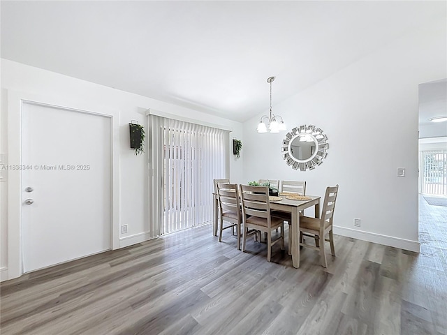 1309 SW 75th Ave, North Lauderdale, FL 33068 - dining room with wood finished floors, a chandelier, and lofted ceiling