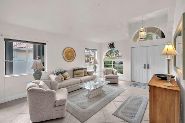 living room with tile patterned floors and a chandelier