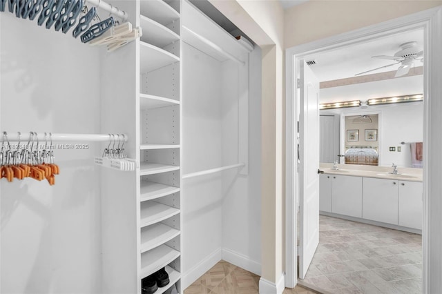 spacious closet featuring ceiling fan and a sink