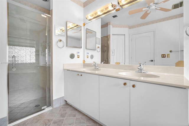 full bath featuring a ceiling fan, double vanity, a stall shower, and tile patterned flooring