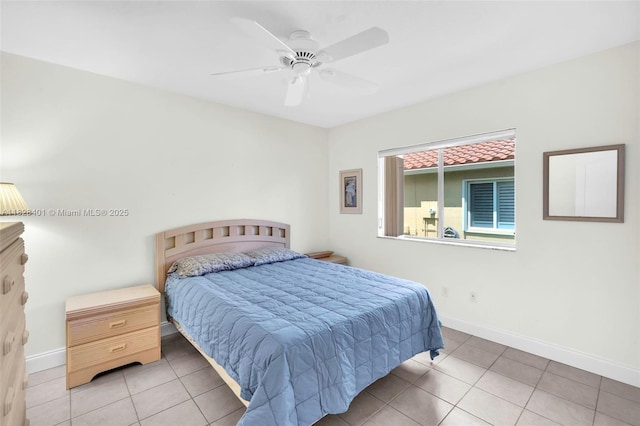 tiled bedroom with baseboards and ceiling fan