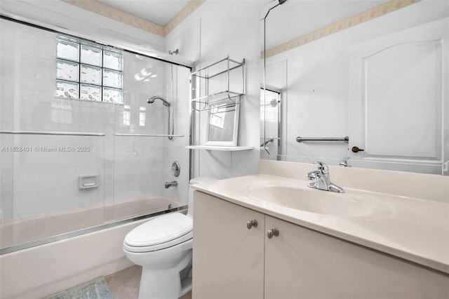 bathroom with vanity, bath / shower combo with glass door, and tile patterned floors