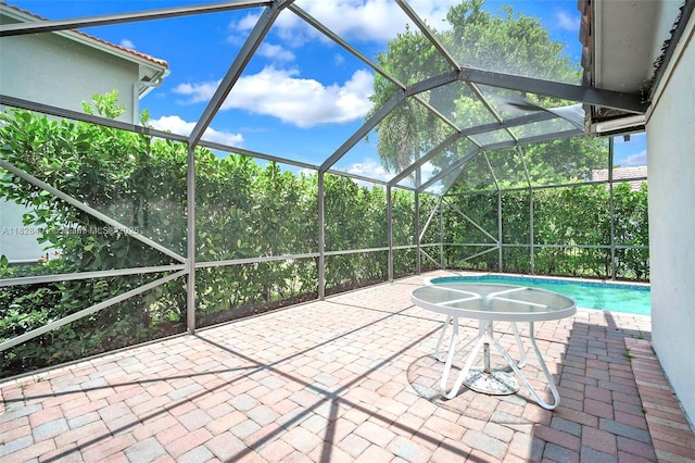 outdoor pool with a patio area and a lanai
