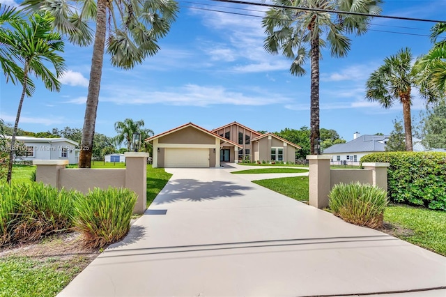 14100 SW 21st St, Davie, FL 33325 - view of front of property featuring a fenced front yard, driveway, stucco siding, and an attached garage