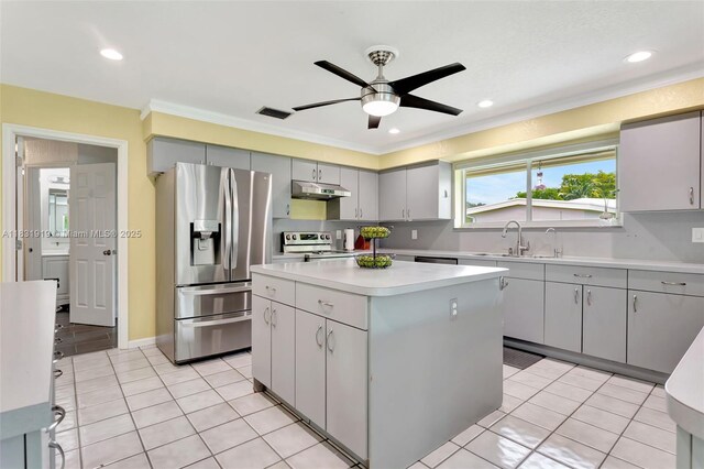 14100 SW 21st St, Davie, FL 33325 - kitchen featuring appliances with stainless steel finishes, under cabinet range hood, a kitchen island, ornamental molding, and gray cabinets
