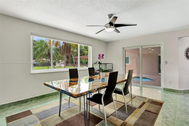 14100 SW 21st St, Davie, FL 33325 - dining room featuring ceiling fan, a textured ceiling, and light tile patterned floors