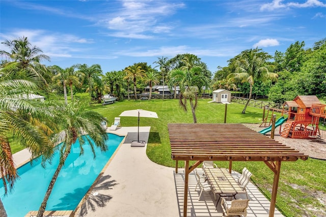 14100 SW 21st St, Davie, FL 33325 - swimming pool featuring a storage unit, view of scattered trees, and a patio