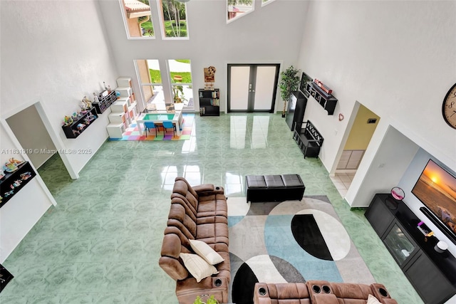 14100 SW 21st St, Davie, FL 33325 - tiled living room featuring a high ceiling, french doors, and healthy amount of natural light