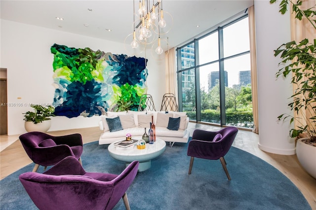 650 NE 32nd St Unit 2205, Miami, FL 33137 - living room with a chandelier, a wall of windows, wood finished floors, and a view of city