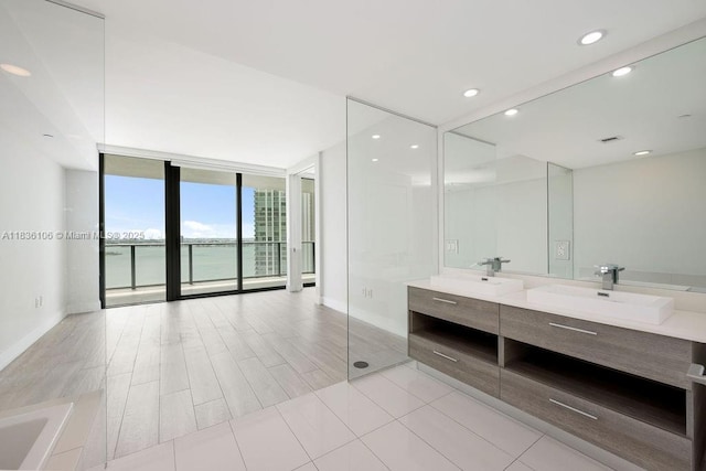 650 NE 32nd St Unit 2205, Miami, FL 33137 - full bathroom featuring double vanity, floor to ceiling windows, recessed lighting, a water view, and a bathtub