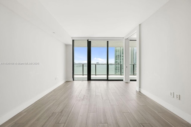 650 NE 32nd St Unit 2205, Miami, FL 33137 - unfurnished room with wood finished floors and floor to ceiling windows