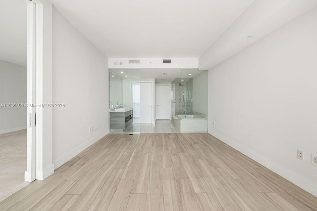 650 NE 32nd St Unit 2205, Miami, FL 33137 - empty room featuring light wood-style floors and a sink
