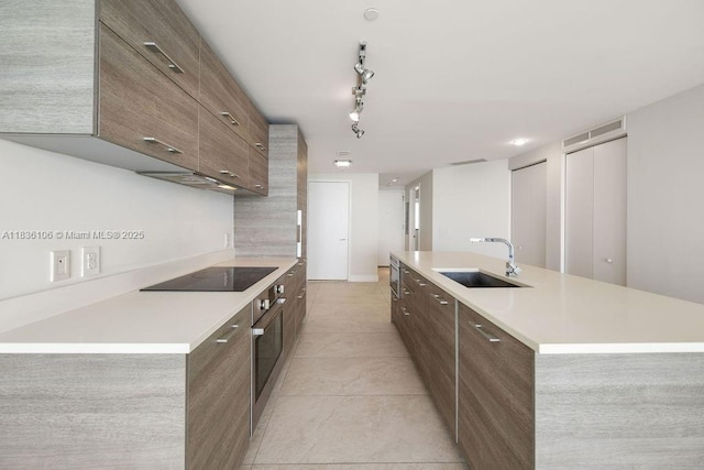 650 NE 32nd St Unit 2205, Miami, FL 33137 - kitchen featuring black electric stovetop, modern cabinets, oven, and light countertops