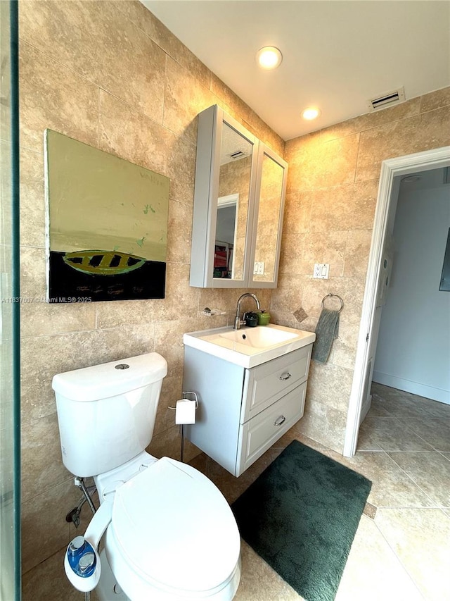 117 Almar Dr, Wilton Manors, FL 33334 - bathroom featuring tile walls, vanity, and tile patterned floors