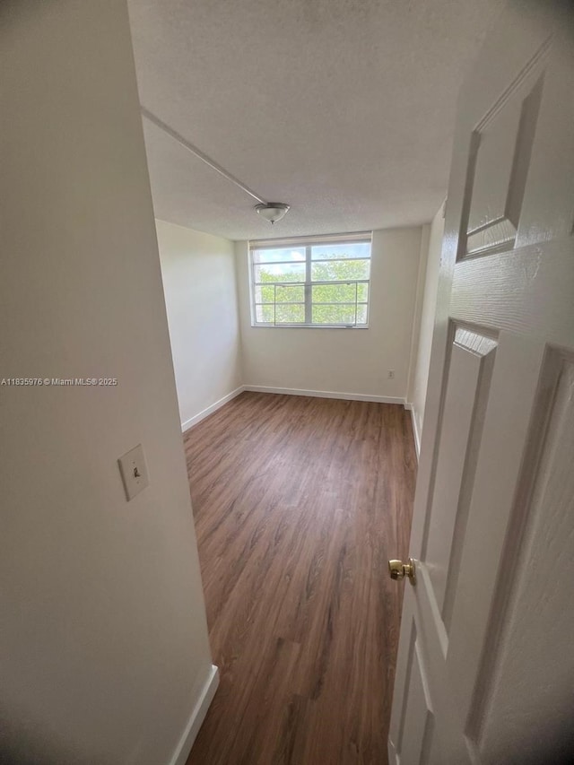 14180 SW 84th St Unit 407-G, Miami, FL 33183 - spare room with wood finished floors and baseboards