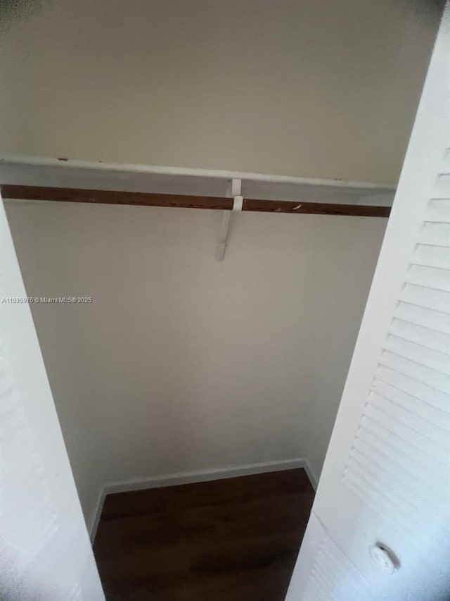 14180 SW 84th St Unit 407-G, Miami, FL 33183 - walk in closet featuring dark wood finished floors
