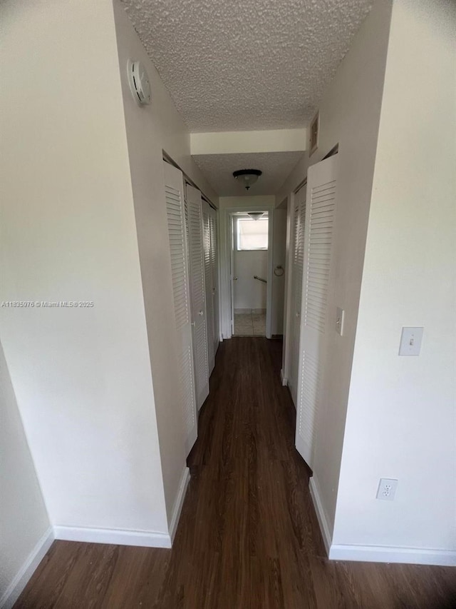 14180 SW 84th St Unit 407-G, Miami, FL 33183 - hall featuring wood finished floors and a textured ceiling