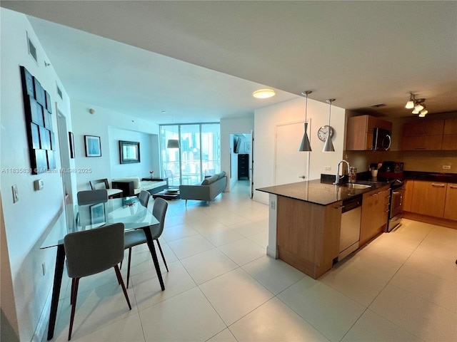 350 S Miami Ave Unit 2303, Miami, FL 33130 - kitchen featuring appliances with stainless steel finishes, dark countertops, brown cabinetry, open floor plan, and light tile patterned floors