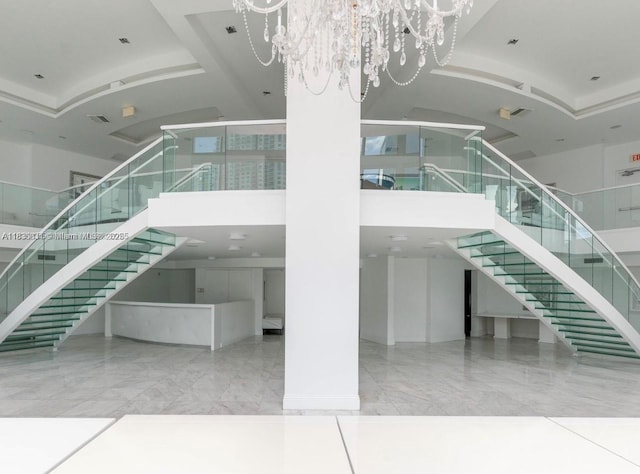 350 S Miami Ave Unit 2303, Miami, FL 33130 - stairway featuring a towering ceiling, a chandelier, and marble finish flooring