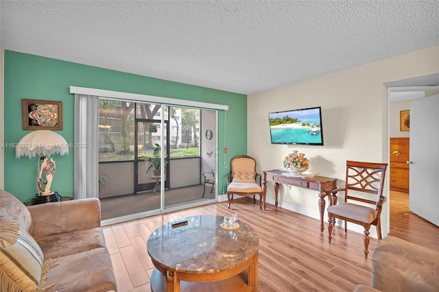 801 SW 138th Ave Unit 103E, Pembroke Pines, FL 33027 - living room featuring a textured ceiling and wood finished floors