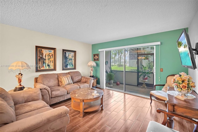 801 SW 138th Ave Unit 103E, Pembroke Pines, FL 33027 - living area with a textured ceiling and wood finished floors
