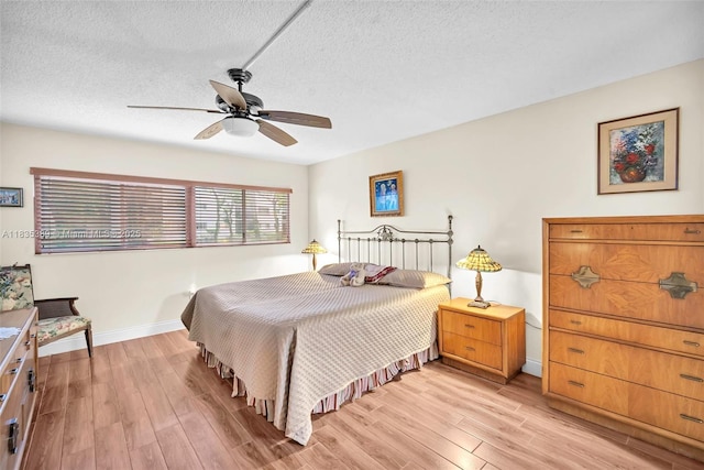 801 SW 138th Ave Unit 103E, Pembroke Pines, FL 33027 - bedroom with light wood-type flooring, a textured ceiling, and ceiling fan