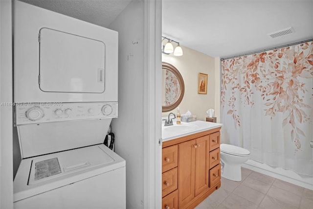 801 SW 138th Ave Unit 103E, Pembroke Pines, FL 33027 - washroom with stacked washer / dryer and light tile patterned flooring