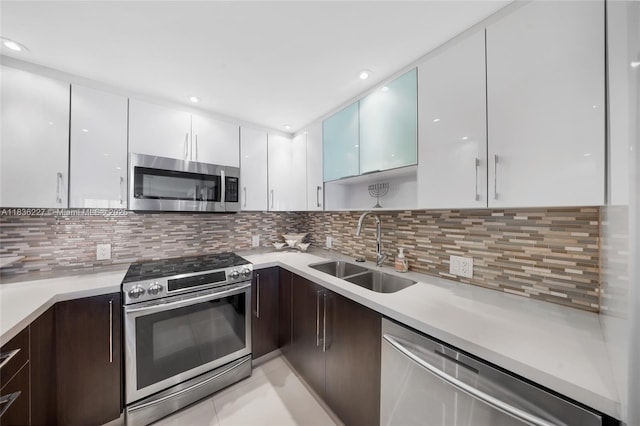 100 Bayview Dr Unit 1905, Sunny Isles Beach, FL 33160 - kitchen featuring stainless steel appliances, modern cabinets, white cabinetry, light countertops, and decorative backsplash