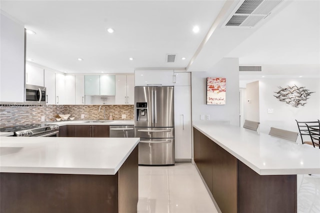 100 Bayview Dr Unit 1905, Sunny Isles Beach, FL 33160 - kitchen featuring stainless steel appliances, a peninsula, light countertops, and recessed lighting