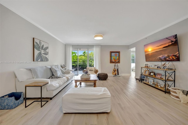 7588 SW 102nd St Unit 203, Pinecrest, FL 33156 - living room featuring crown molding, wood finished floors, and plenty of natural light