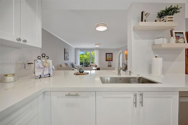 7588 SW 102nd St Unit 203, Pinecrest, FL 33156 - kitchen featuring open shelves, light countertops, white cabinets, a peninsula, and open floor plan
