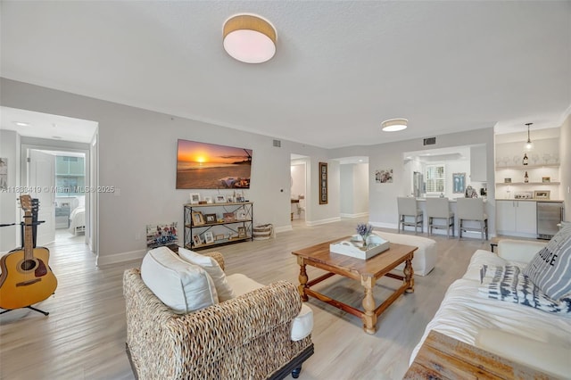 7588 SW 102nd St Unit 203, Pinecrest, FL 33156 - living room featuring light wood-type flooring and baseboards