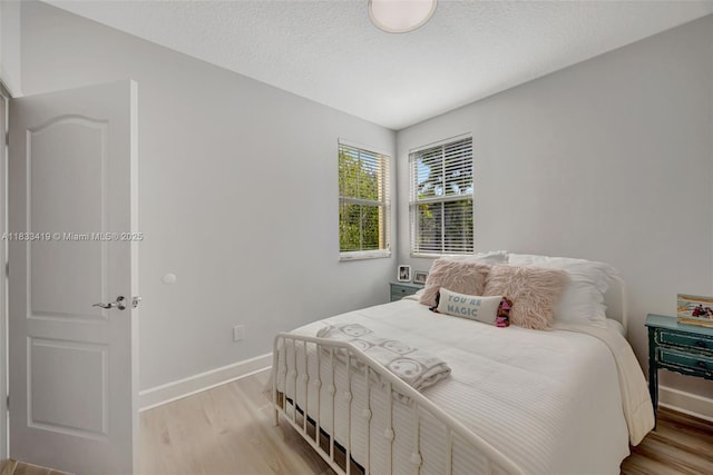 7588 SW 102nd St Unit 203, Pinecrest, FL 33156 - bedroom with light wood-style floors and a textured ceiling