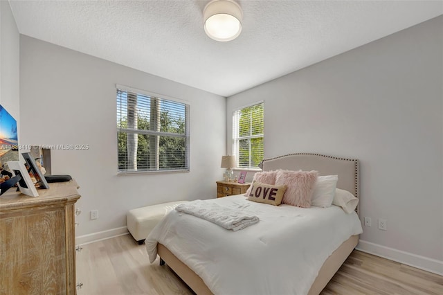 7588 SW 102nd St Unit 203, Pinecrest, FL 33156 - bedroom with wood finished floors and a textured ceiling