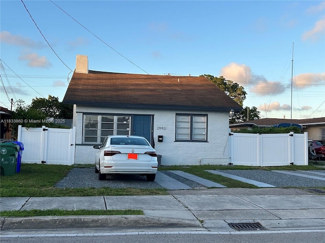 2993 SW 16th Ter, Miami, FL 33145 - bungalow-style home featuring stucco siding, a shingled roof, a chimney, and a gate