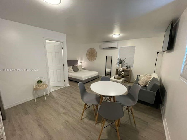 2993 SW 16th Ter, Miami, FL 33145 - dining room featuring a wall mounted AC and wood finished floors