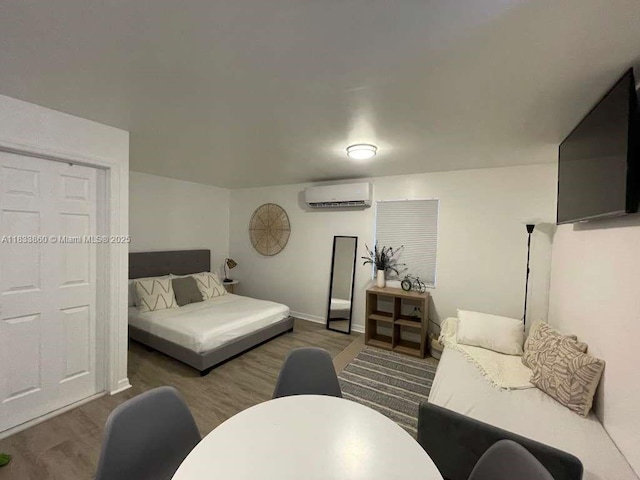 2993 SW 16th Ter, Miami, FL 33145 - bedroom with an AC wall unit and wood finished floors