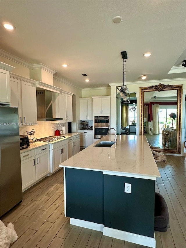 799 Hookline Cir, Loxahatchee, FL 33470 - kitchen featuring appliances with stainless steel finishes, ornamental molding, white cabinetry, a center island with sink, and backsplash
