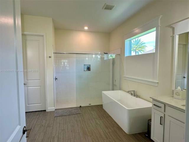 799 Hookline Cir, Loxahatchee, FL 33470 - full bath with a freestanding bath, a shower stall, wood finished floors, vanity, and recessed lighting