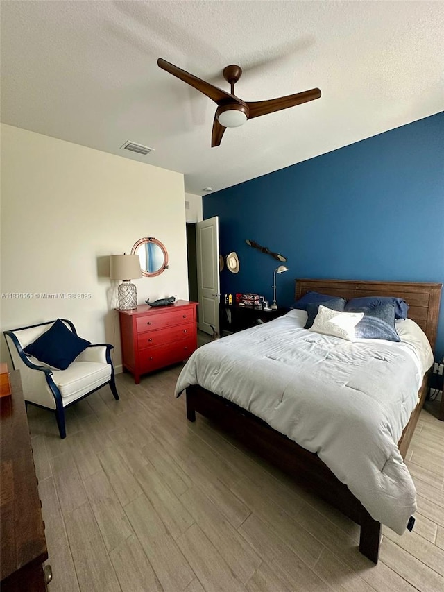799 Hookline Cir, Loxahatchee, FL 33470 - bedroom featuring wood finished floors, ceiling fan, and a textured ceiling