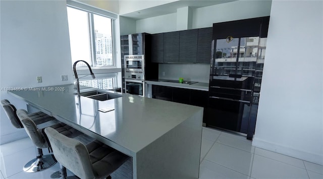 1080 Brickell Ave Unit 4209, Miami, FL 33131 - kitchen with appliances with stainless steel finishes, a kitchen breakfast bar, dark cabinets, modern cabinets, and a peninsula
