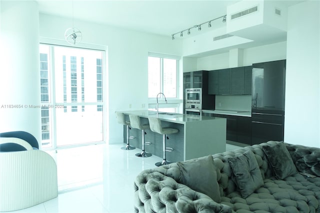 1080 Brickell Ave Unit 4209, Miami, FL 33131 - kitchen with stainless steel appliances, a breakfast bar area, modern cabinets, light tile patterned floors, and a peninsula