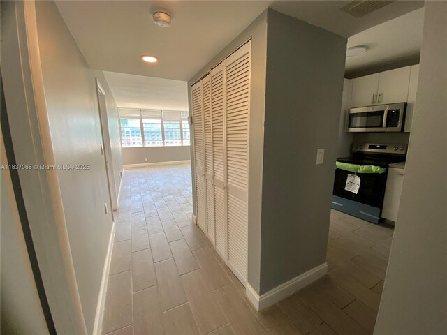 2025 NE 164th St Unit 807, North Miami Beach, FL 33162 - hallway with wood tiled floors and recessed lighting