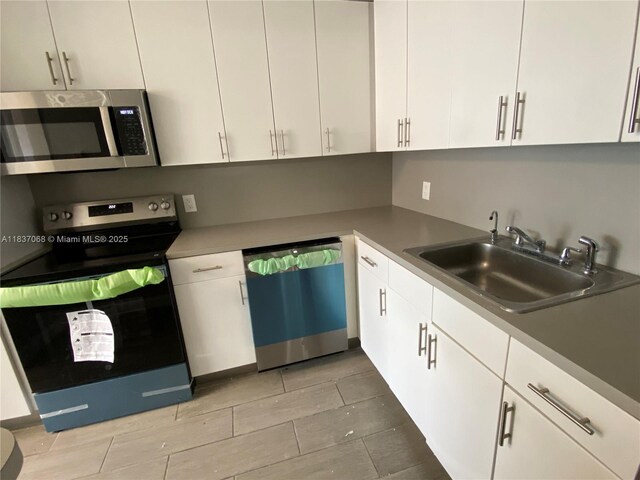 2025 NE 164th St Unit 807, North Miami Beach, FL 33162 - kitchen with appliances with stainless steel finishes and white cabinets