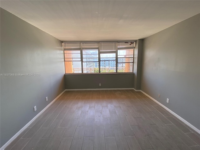 2025 NE 164th St Unit 807, North Miami Beach, FL 33162 - spare room with dark wood-style floors and baseboards