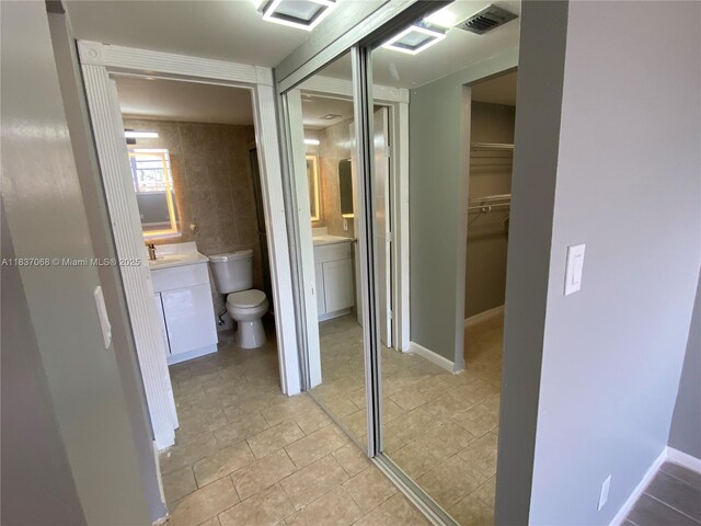 2025 NE 164th St Unit 807, North Miami Beach, FL 33162 - bathroom with vanity and a spacious closet