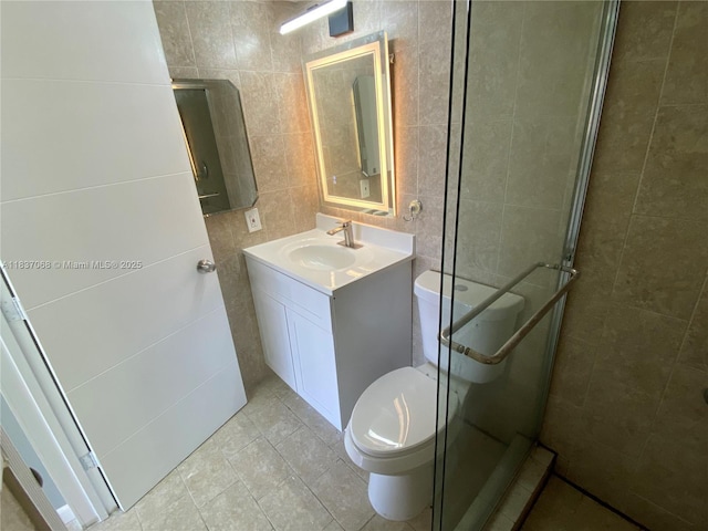 2025 NE 164th St Unit 807, North Miami Beach, FL 33162 - full bathroom featuring tile walls, vanity, a stall shower, and tile patterned floors
