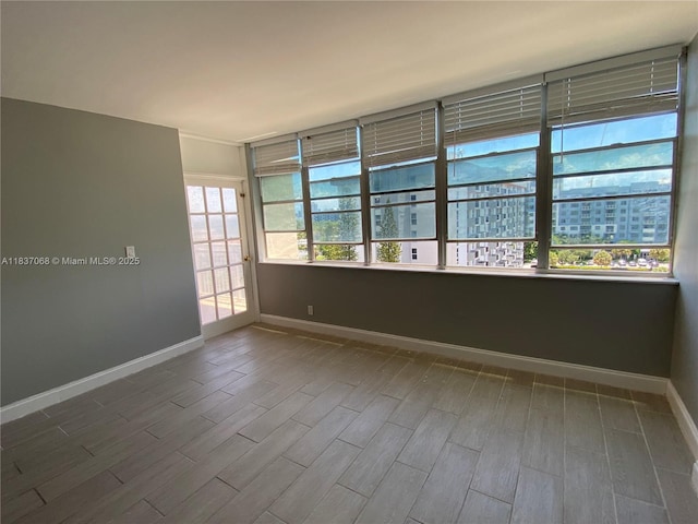 2025 NE 164th St Unit 807, North Miami Beach, FL 33162 - spare room with wood finished floors and baseboards