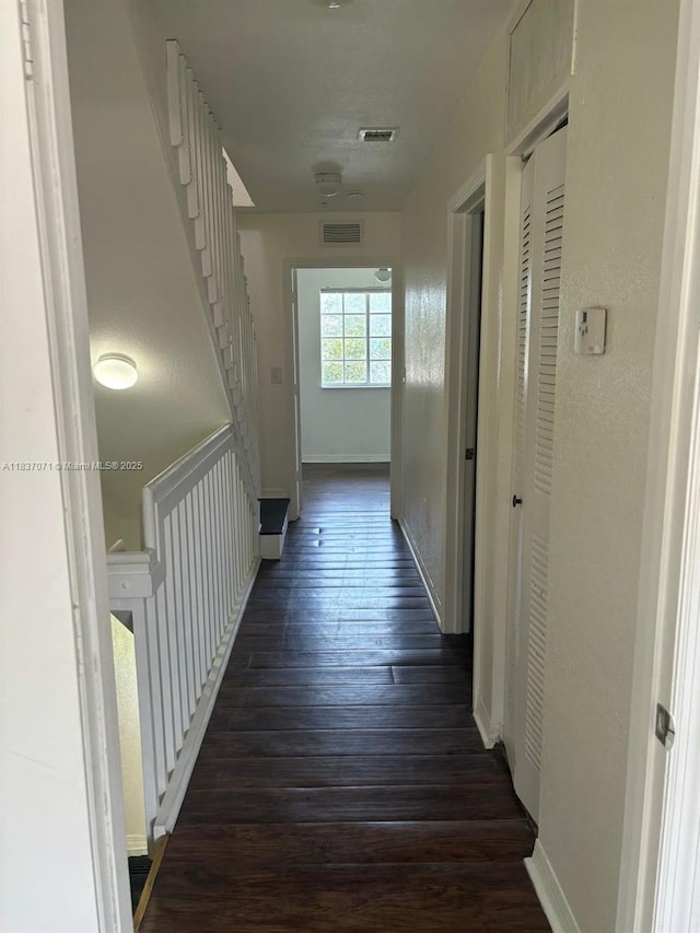 2050 NE 167th St Unit 3-124, North Miami Beach, FL 33162 - hallway with dark wood-style floors and baseboards